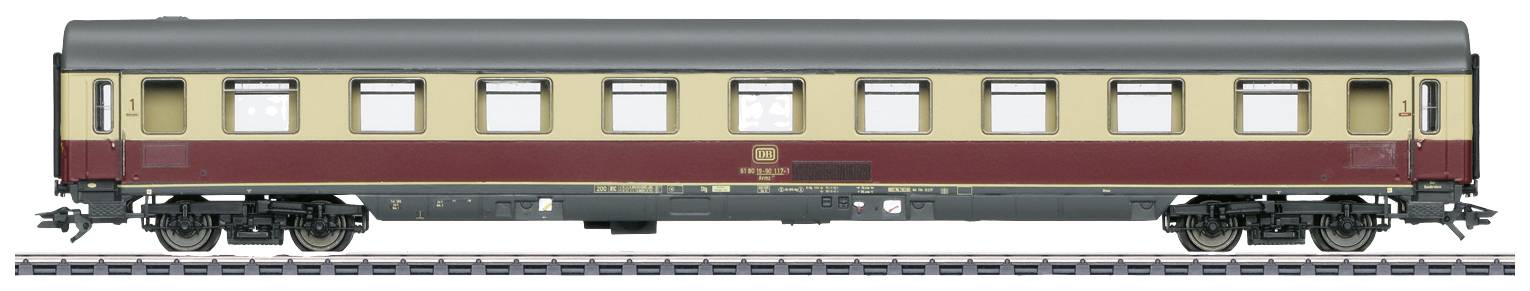 An elegant, two-tone painted railway carriage, yellow and red, stands on railway tracks. The windows are evenly distributed.