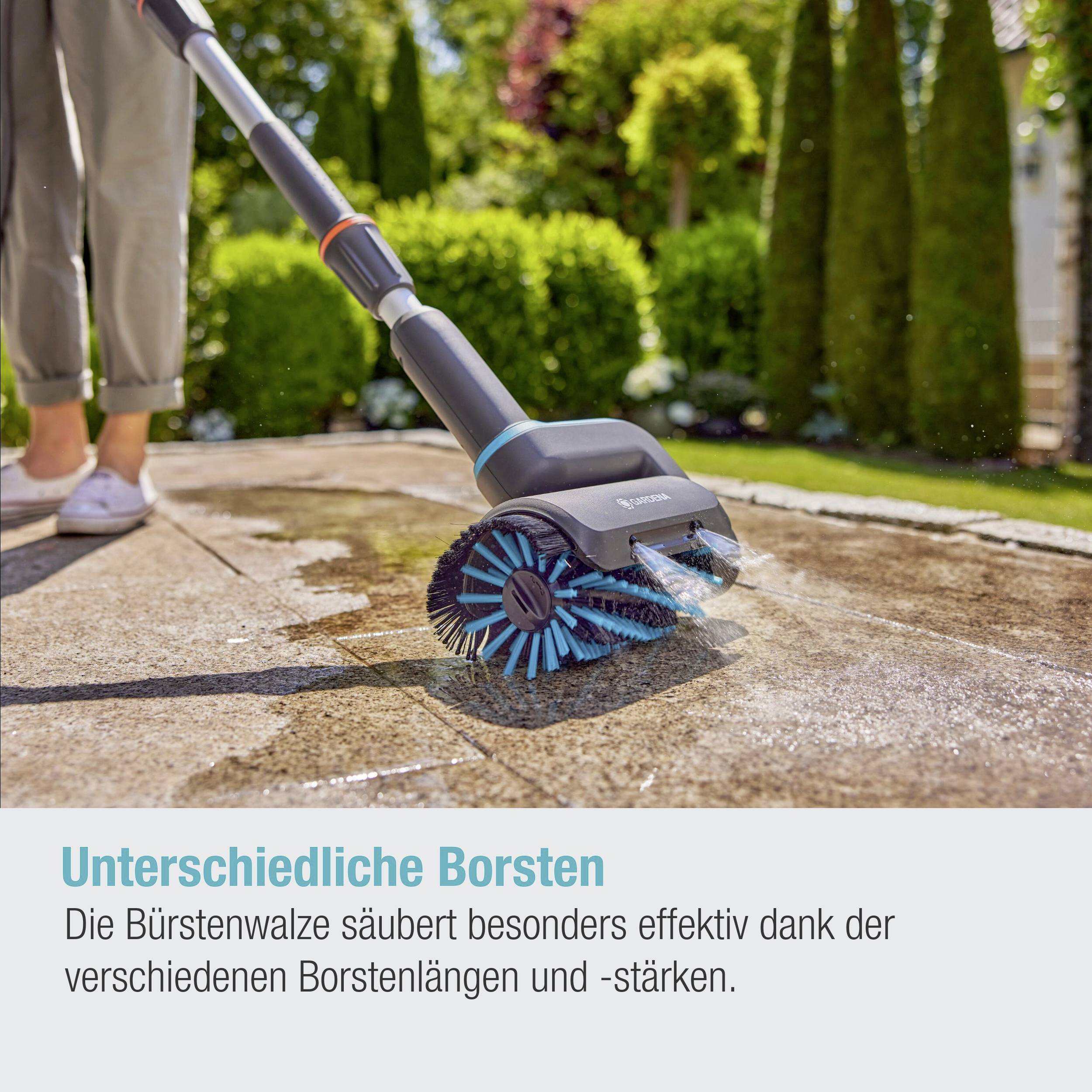 A person is cleaning a stone surface with an electric brush that has different bristle lengths for effective cleaning.