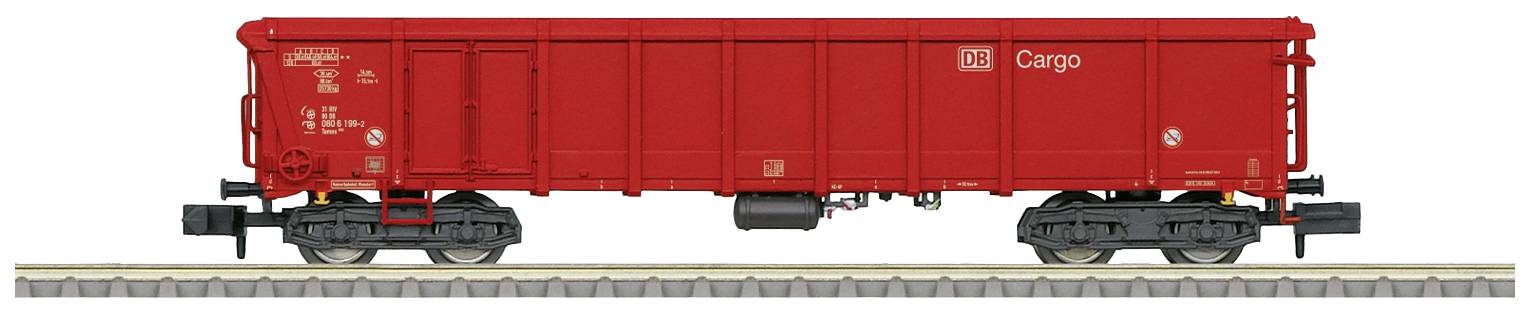 A red goods wagon is standing on a railway track. 'Cargo' is written on its side. The wagon has black wheels and is suitable for transporting goods.