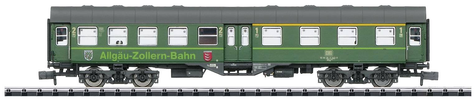 Green model railway carriage of the Allgäu-Zollern Railway on tracks, side view, with detailed windows and printed markings visible.
