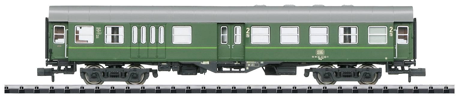 Green and silver model train carriage of the Deutsche Bundesbahn on railway tracks. Side view with detailed windows and doors.