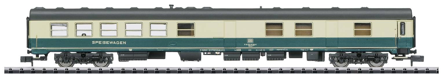Model railway passenger carriage, green and beige design, on a railway track.