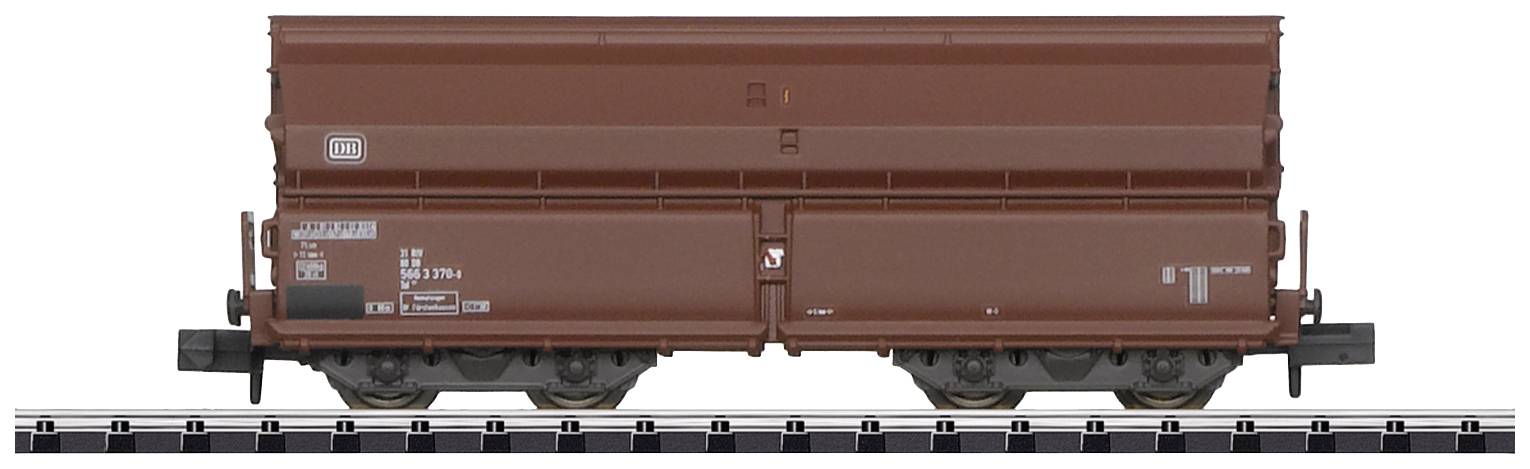 A brown goods wagon stands on a section of railway track. The wagon is simply designed and appears to be part of a train.