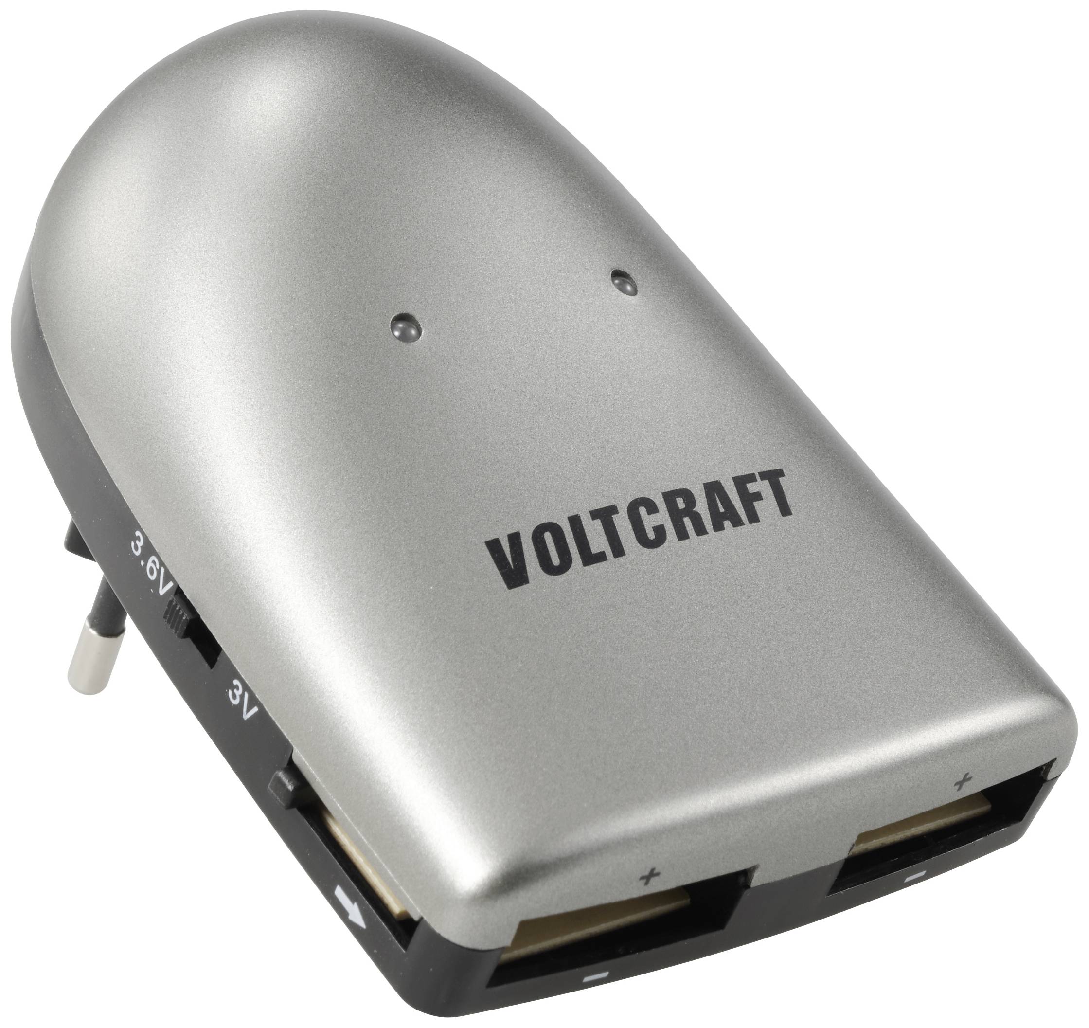Pictured is a silver Voltcraft charger with a mains plug and two USB outputs for power supply.