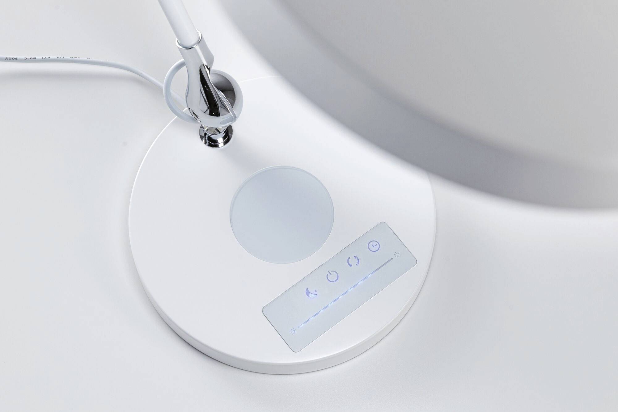 A desk lamp with a touch control panel for brightness adjustment. The design is modern and minimalist.