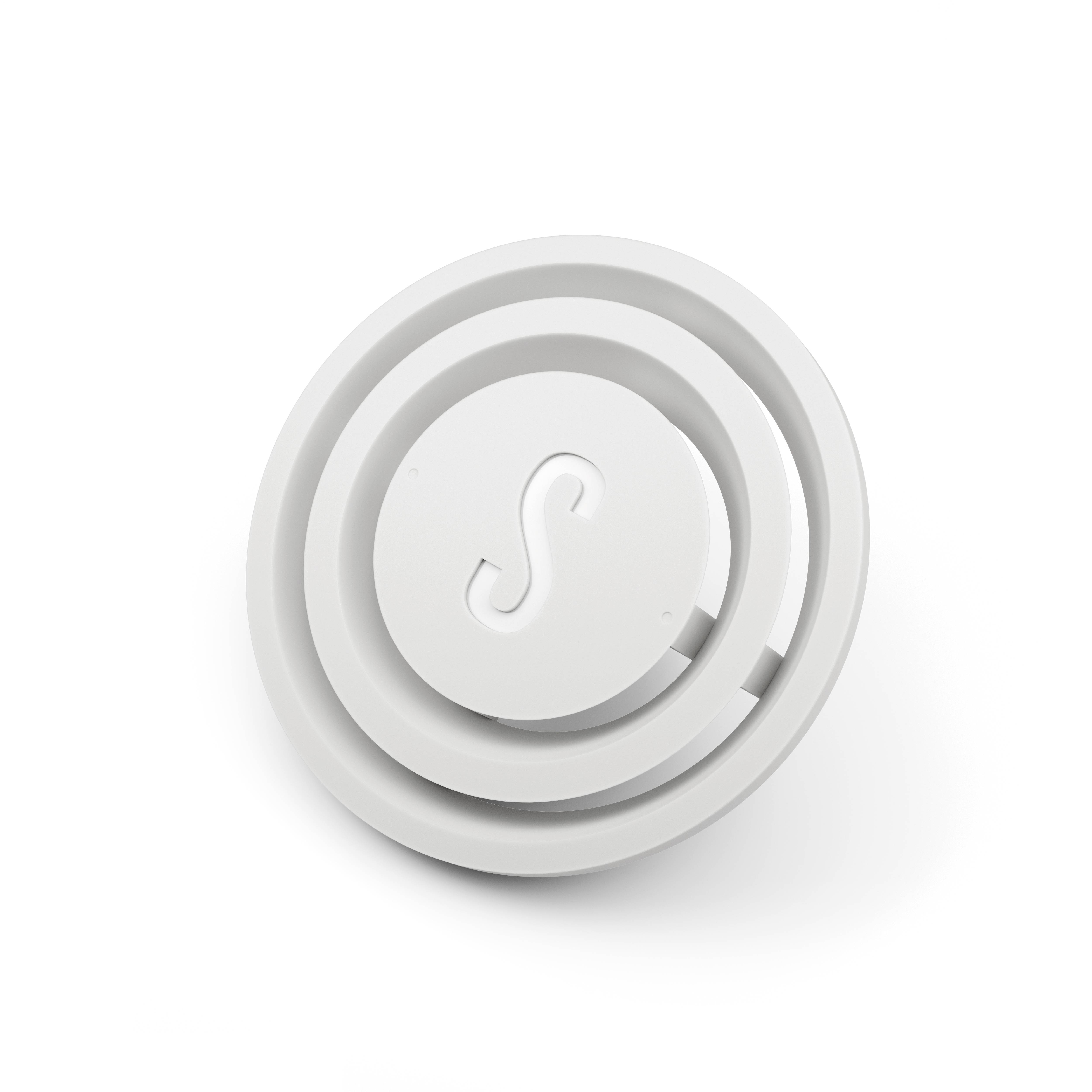 Circular white object with an embossed letter 'S' in the centre, surrounded by concentric rings.