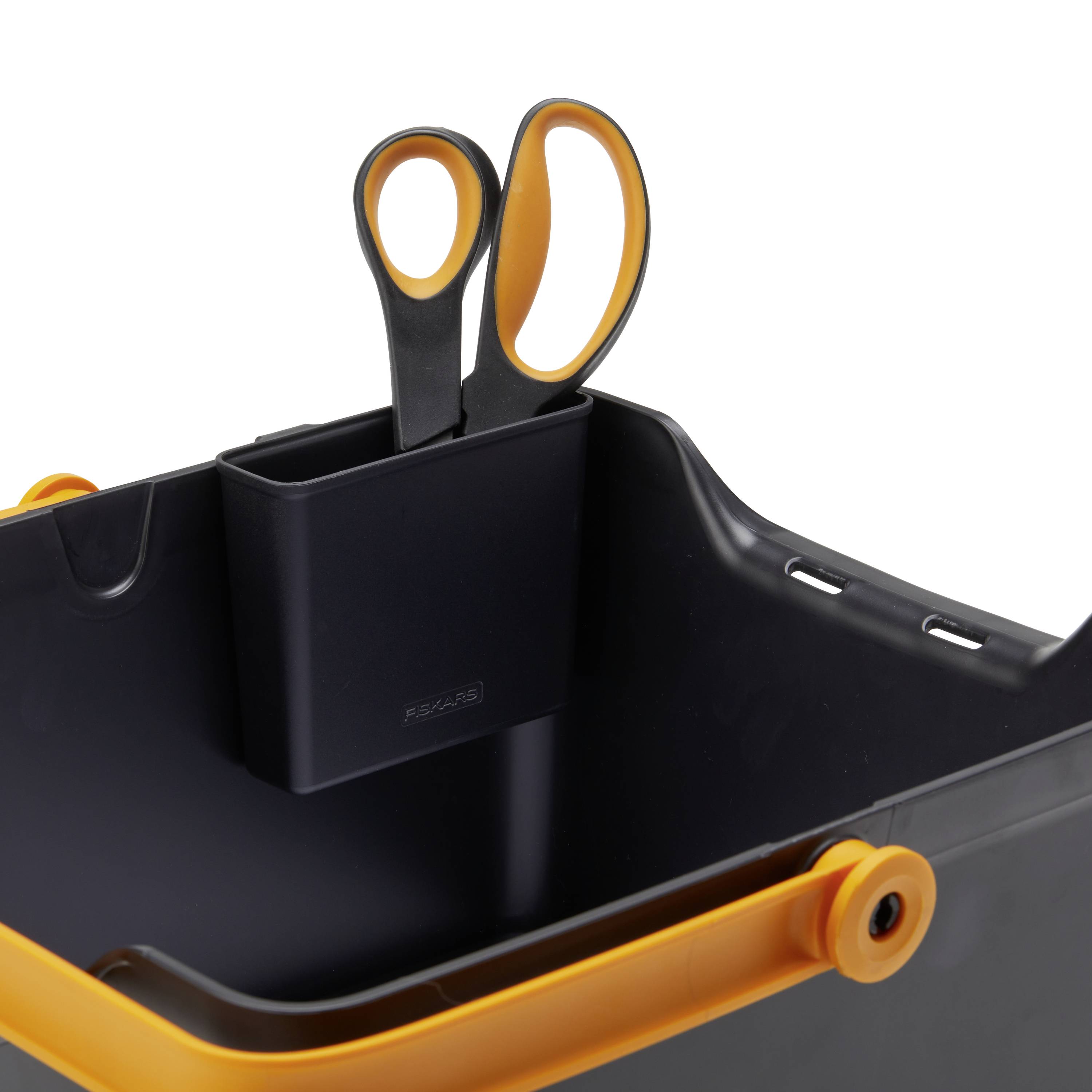 A black storage box with orange handles contains a pair of scissors in an integrated compartment.
