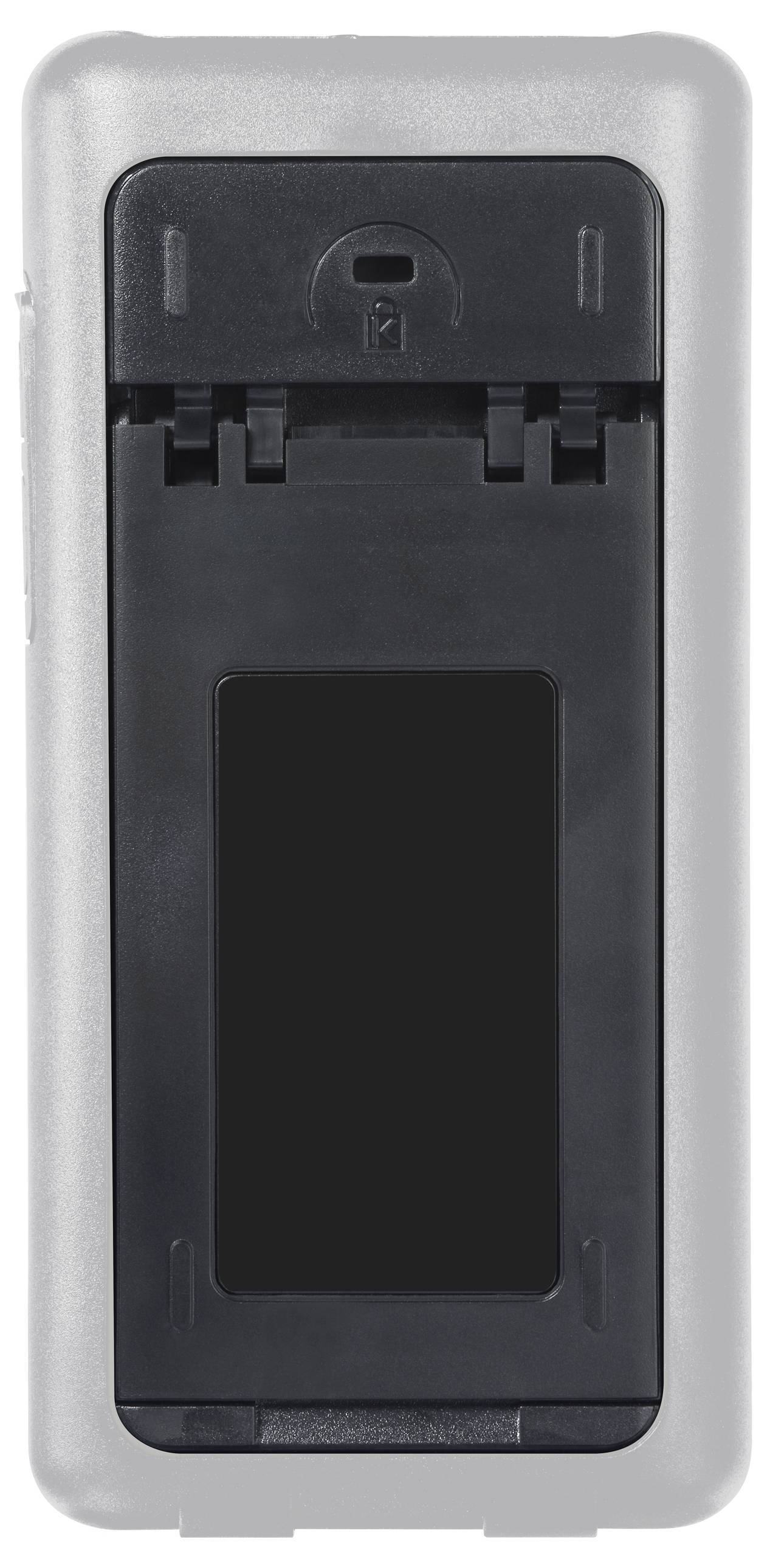 The back of an electronic device, presumably a remote control, with a battery compartment that is open.