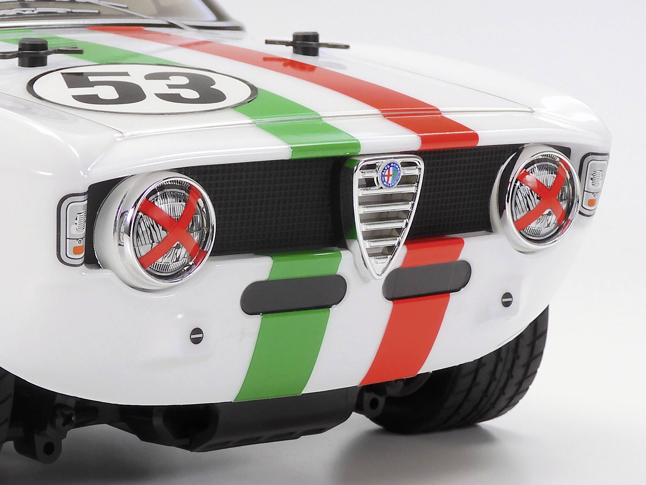 A white model car with the number '53' and red and green stripes on the bonnet. The headlights are marked in red.