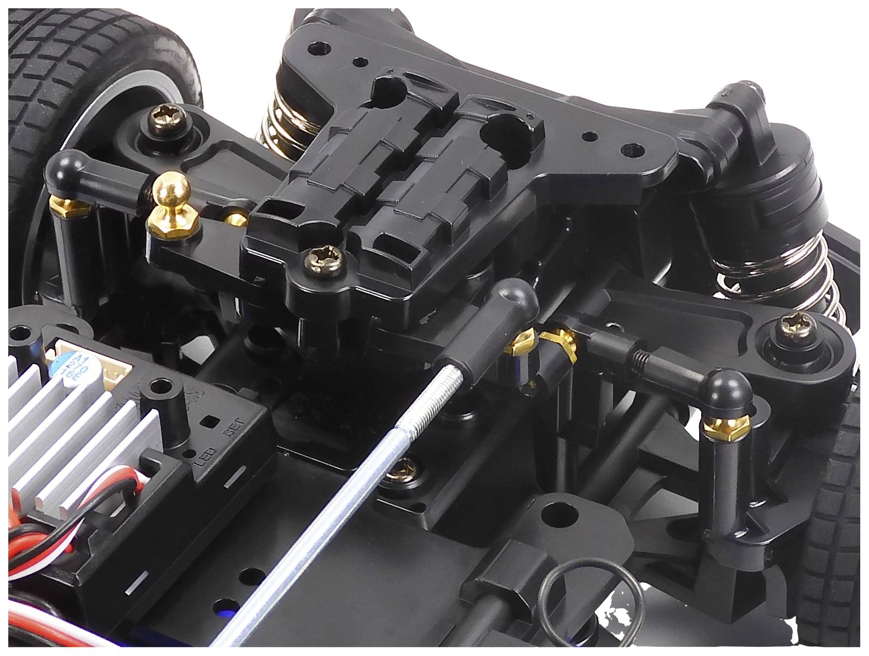 Remote-controlled car chassis, showing the front suspension and power steering mechanism with a detailed view of the components.