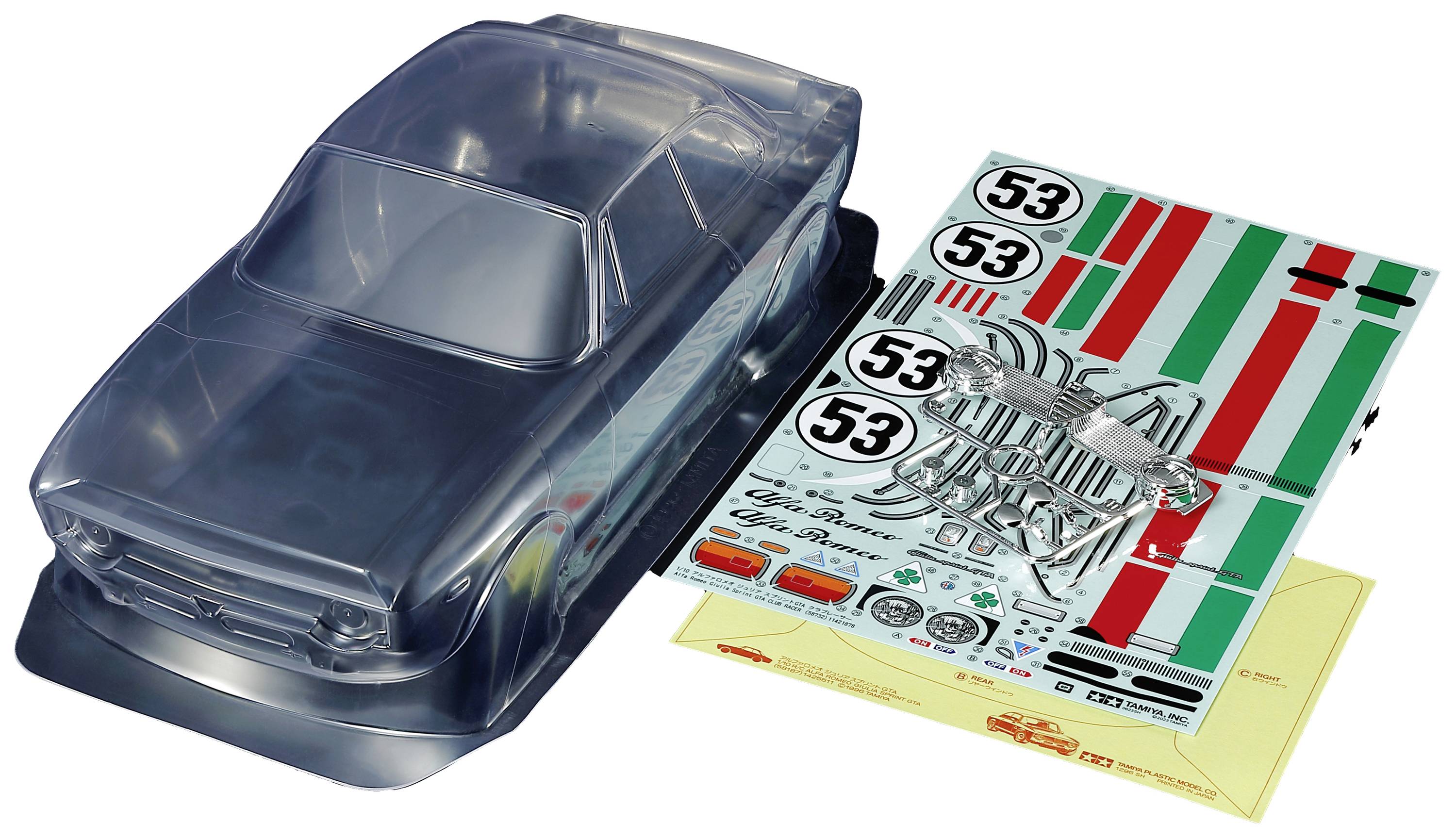 Transparent model car body with a decal sheet featuring numbered stickers and racing stripes, lying on a table.