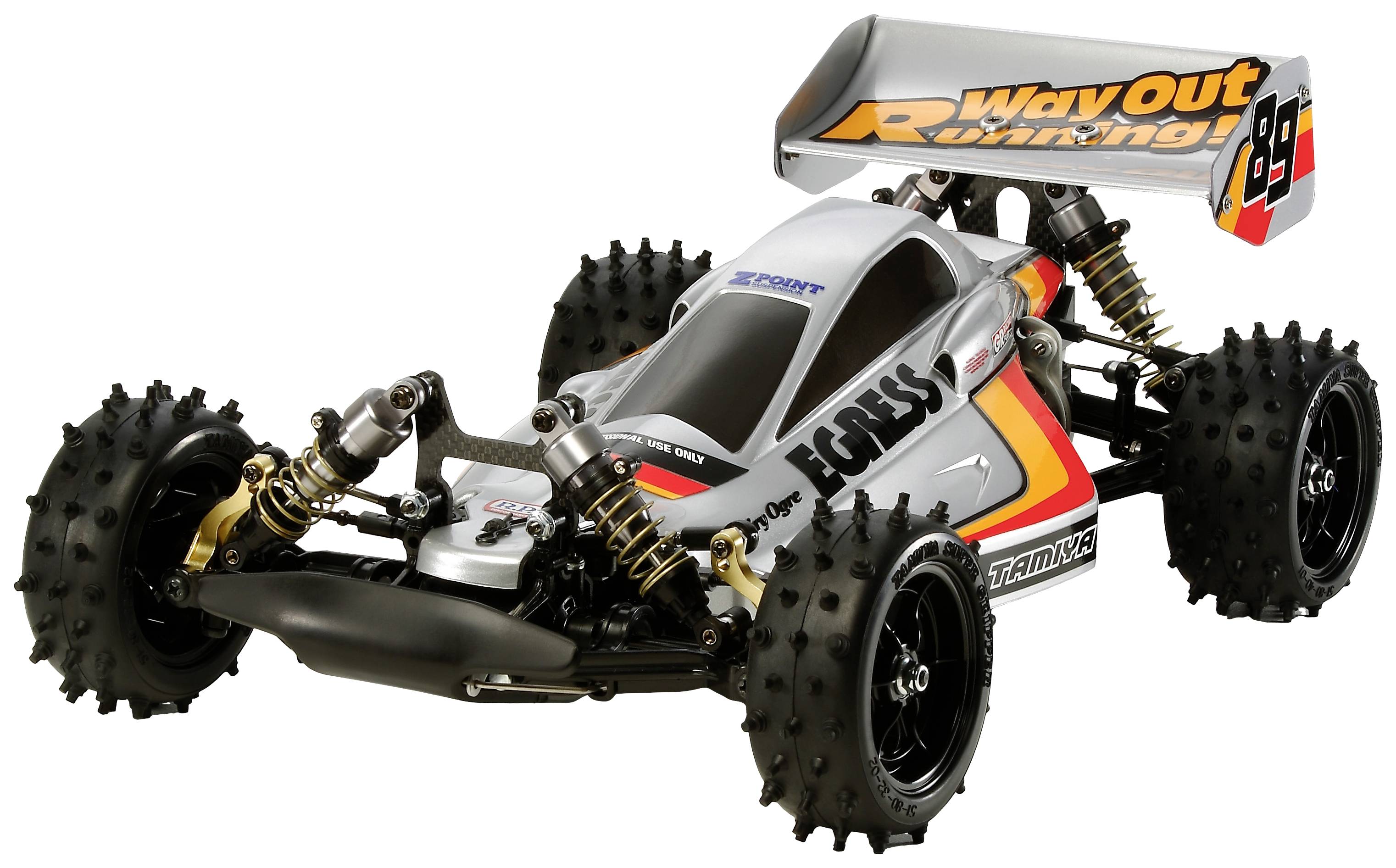 A remote-controlled model car with a large rear spoiler and all-terrain tyres, designed for high speeds and off-road performance.