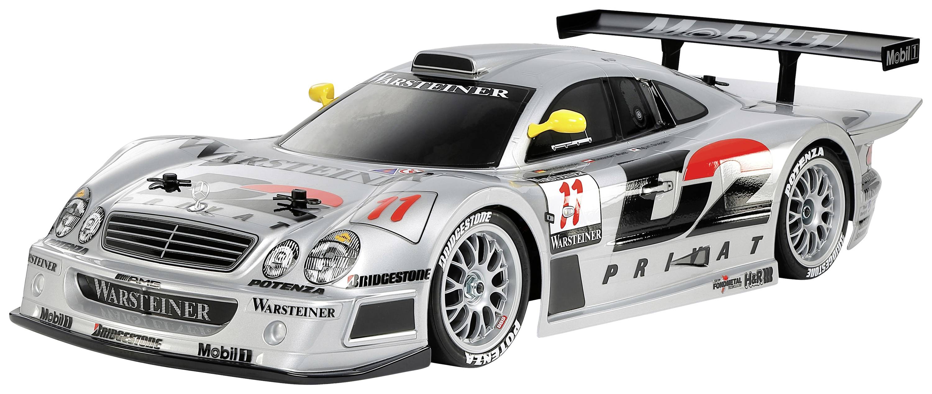 Silver racing car with a wing and advertising, number 11, on a white background. Side profile shows aerodynamic design.