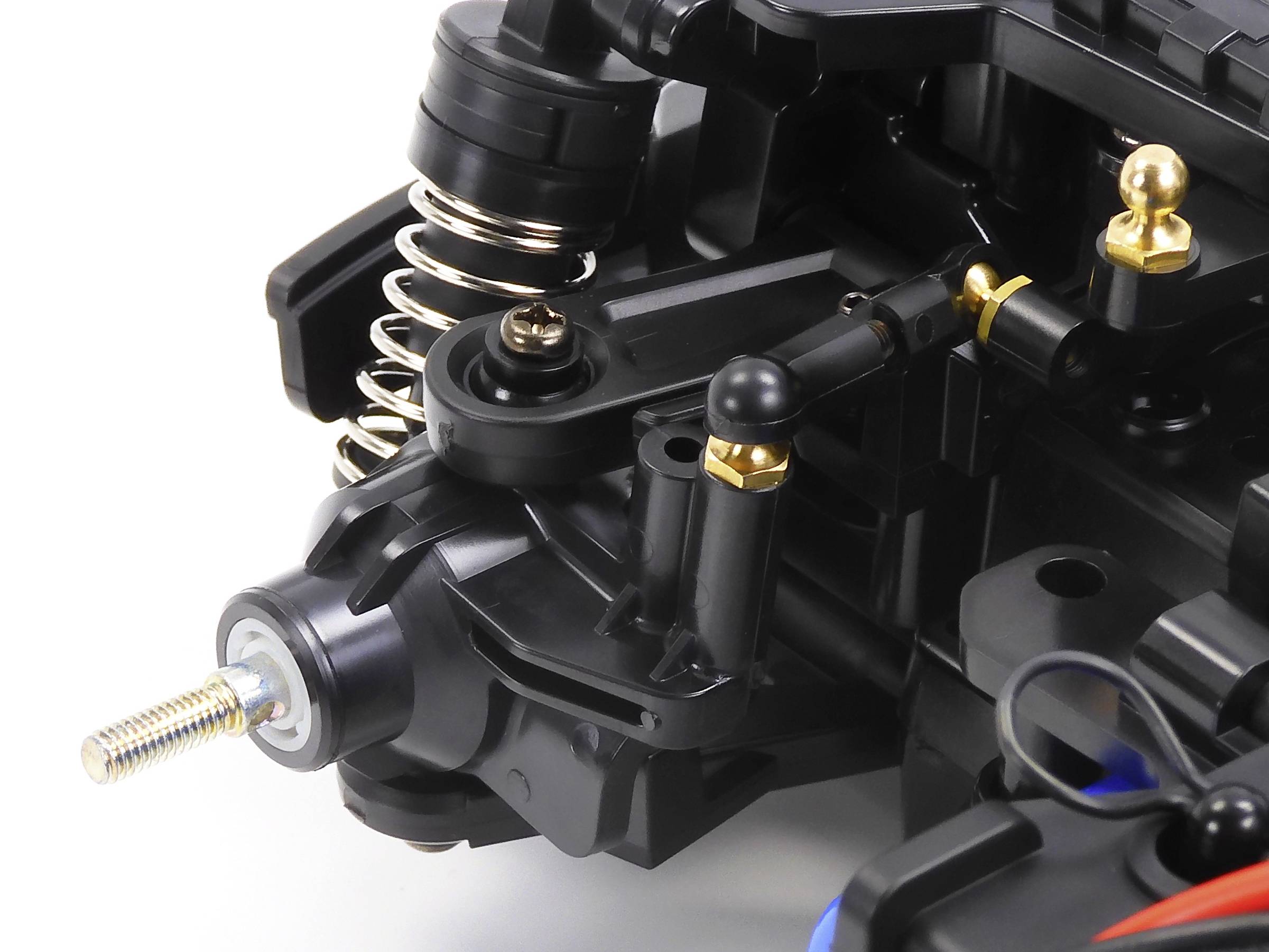 Close-up of a complex mechanical component with springs and connections, which could possibly be part of a model vehicle.