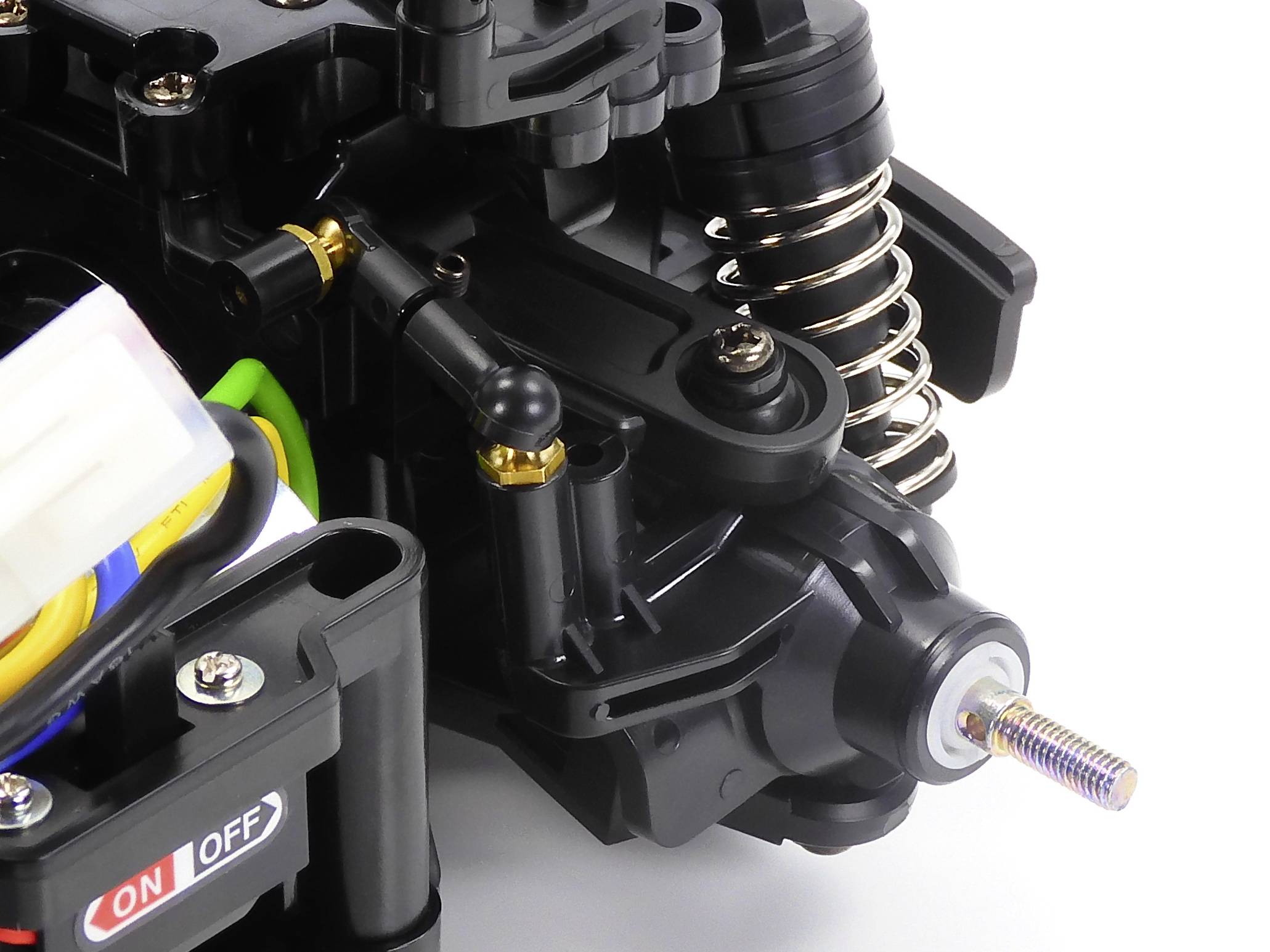 Close-up of a model car suspension system with springs and transmission mechanism.