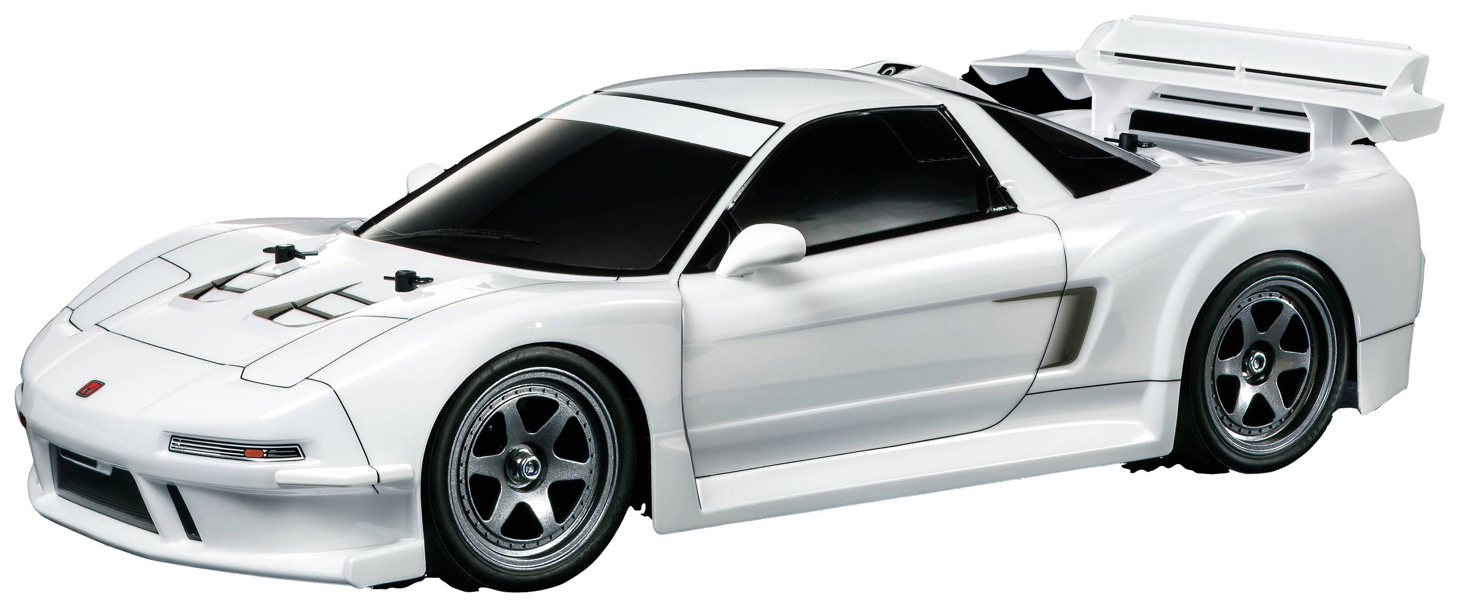 A white sports car model with an aerodynamic design and spoiler, viewed from the side. The car has tinted windows and silver alloy wheels.