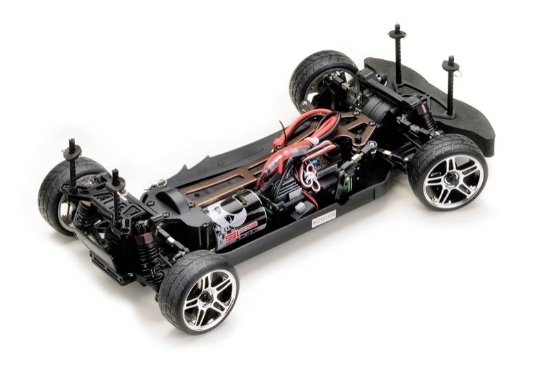 RC auto chassis with four tyres, motor and suspension, ready for body assembly.