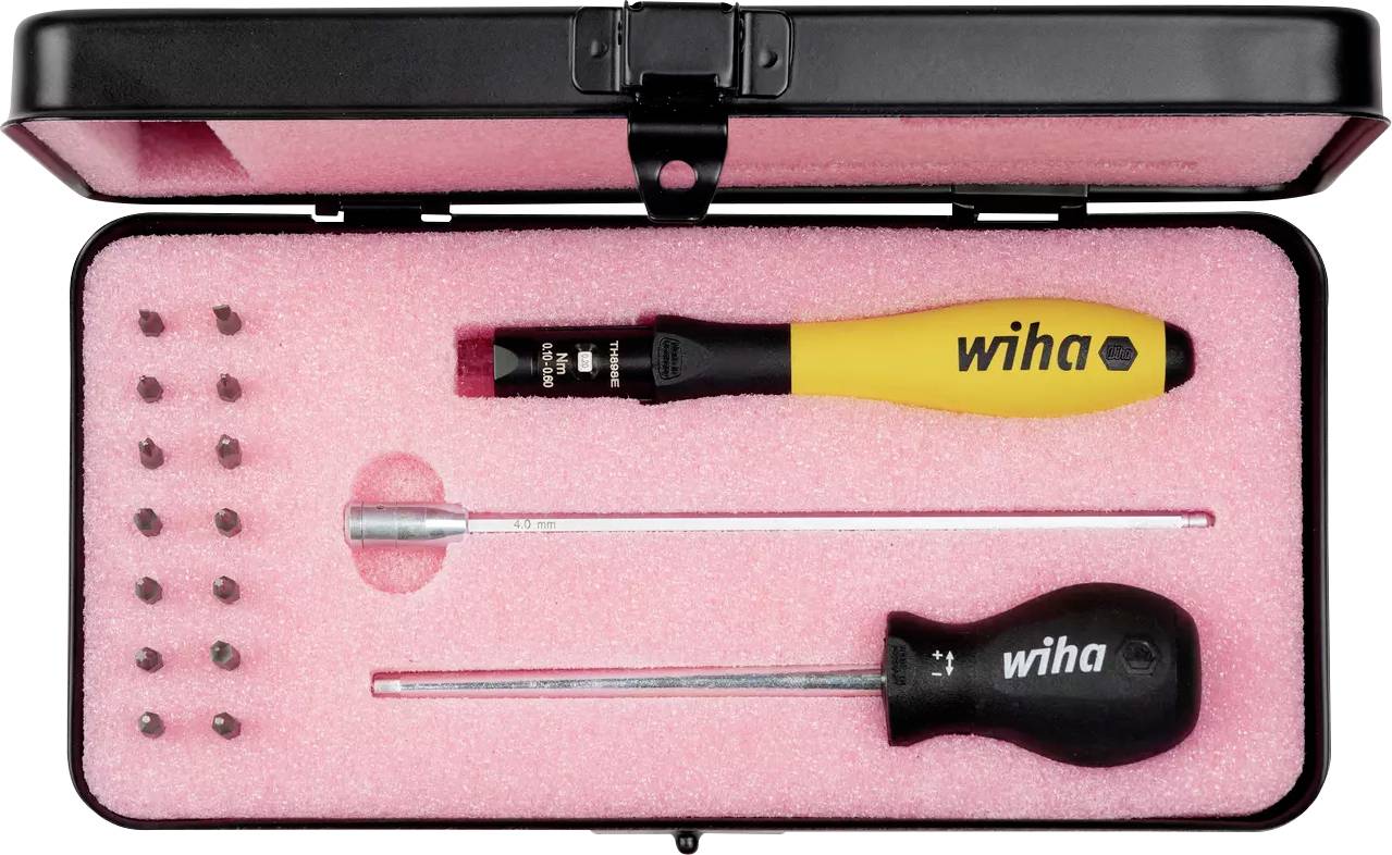 A compact toolkit featuring a variety of screw bits, a yellow-handled screwdriver, and a longer black-handled screwdriver, all set in a pink foam interior.