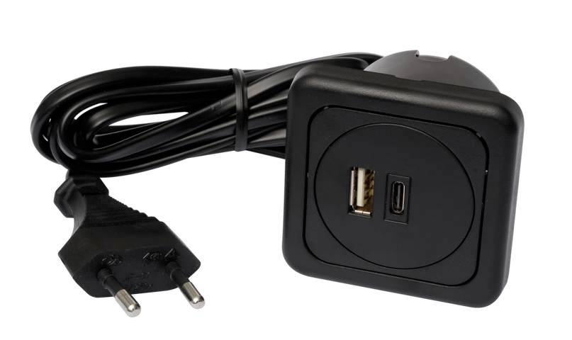 A black, square charger with a USB and USB-C port. Connected to it is a cable with an EU plug.
