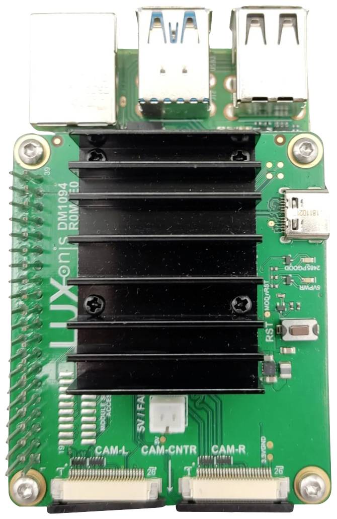 A green circuit board with multiple USB ports, two heatsinks, and camera interfaces; it appears to be a development board.