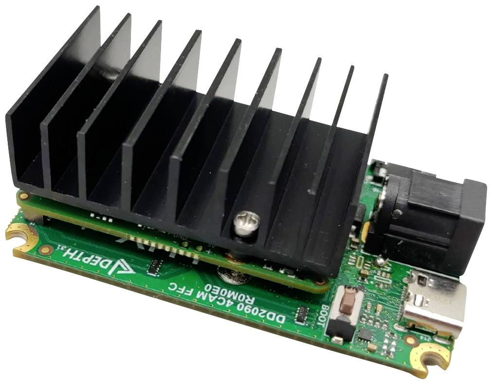 A small green circuit board with a black heat sink, rectangular connector, and multiple electronic components.