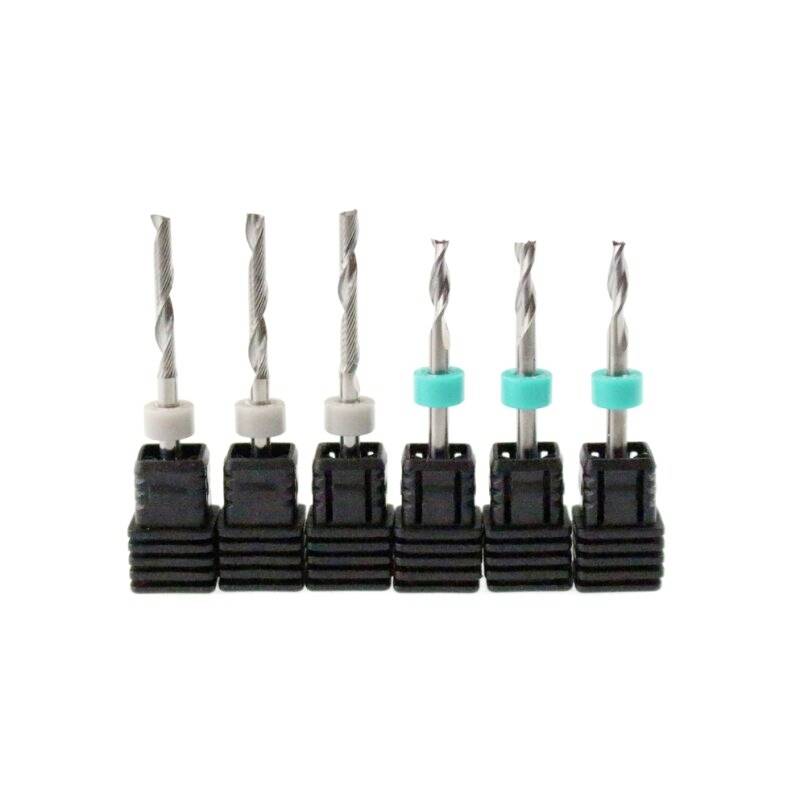 Six metal drill bits with black handles, arranged in a row. Three have white, three blue rings to distinguish their sizes.