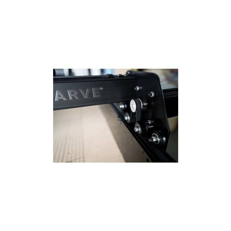 Close-up of a black metal component of a CNC machine with visible screws and belt system.