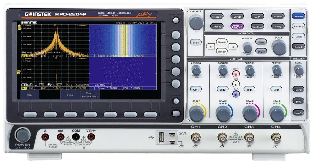 Oscilloscope with display showing spectral analysis. Buttons and connections for control located below. Primary purpose: signal monitoring and analysis.