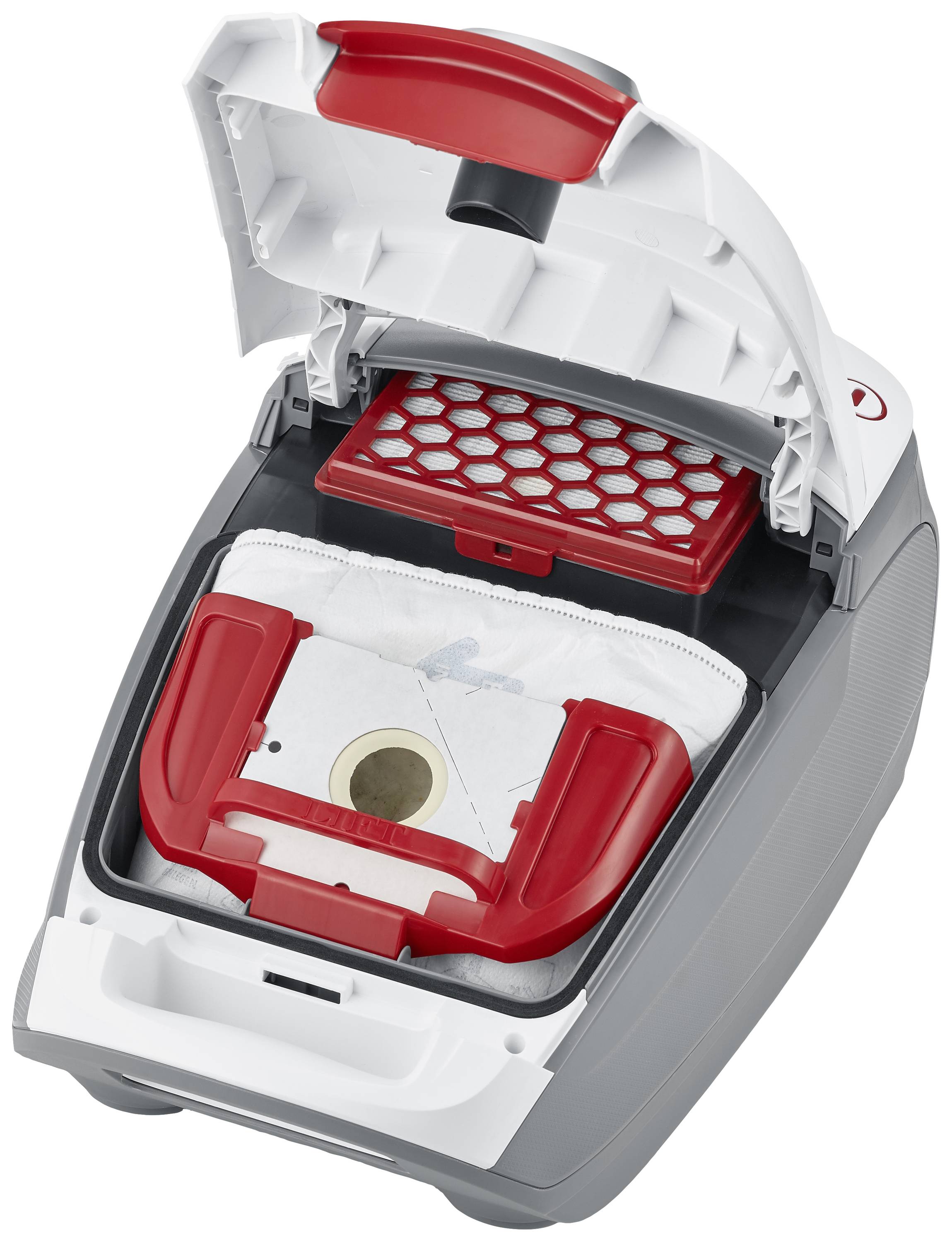Vacuum cleaner with open cover, showing dust bag and filter. The dust bag is white with a red border.