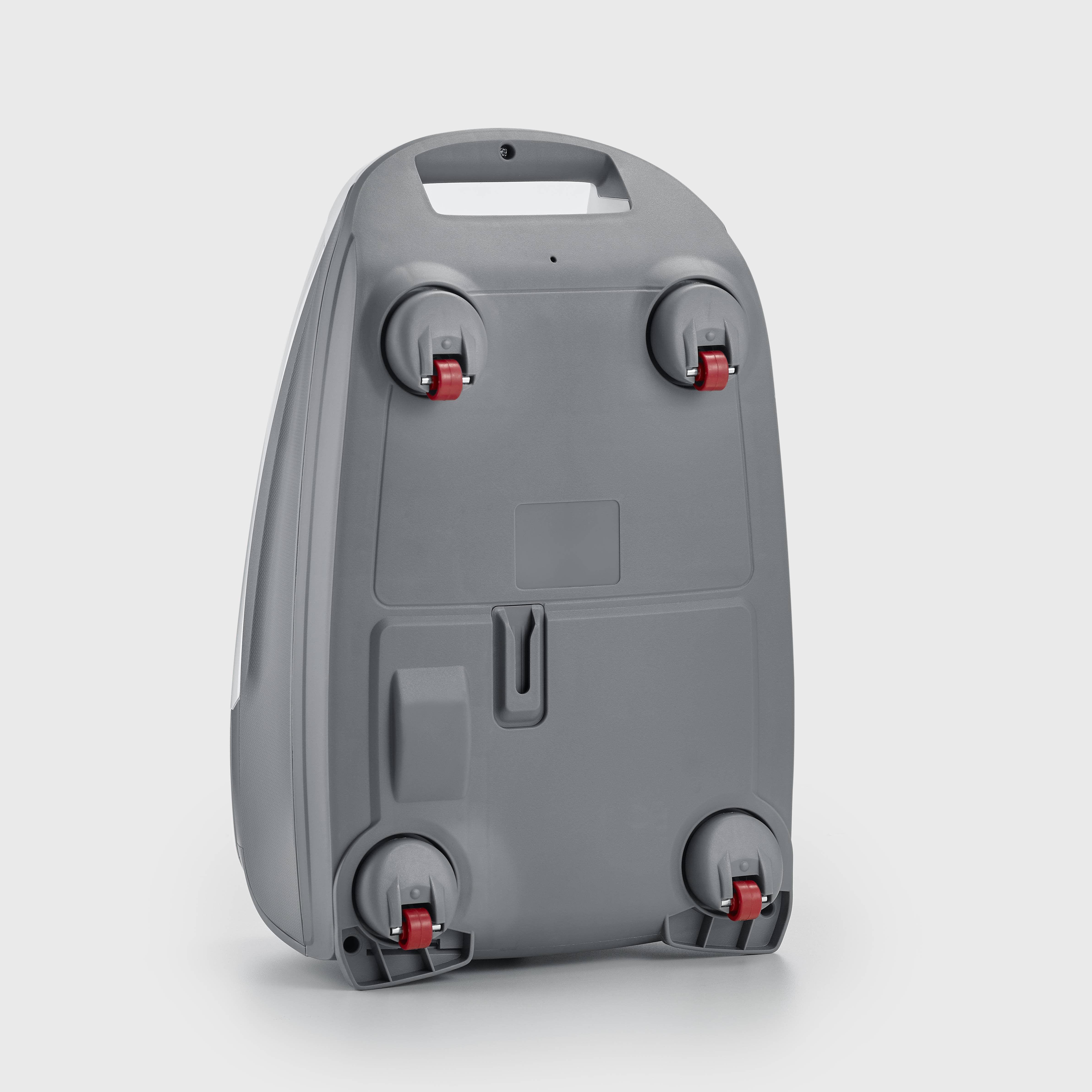 A grey hard-shell suitcase with four wheels and a handle is shown from behind. The wheels have red locks.