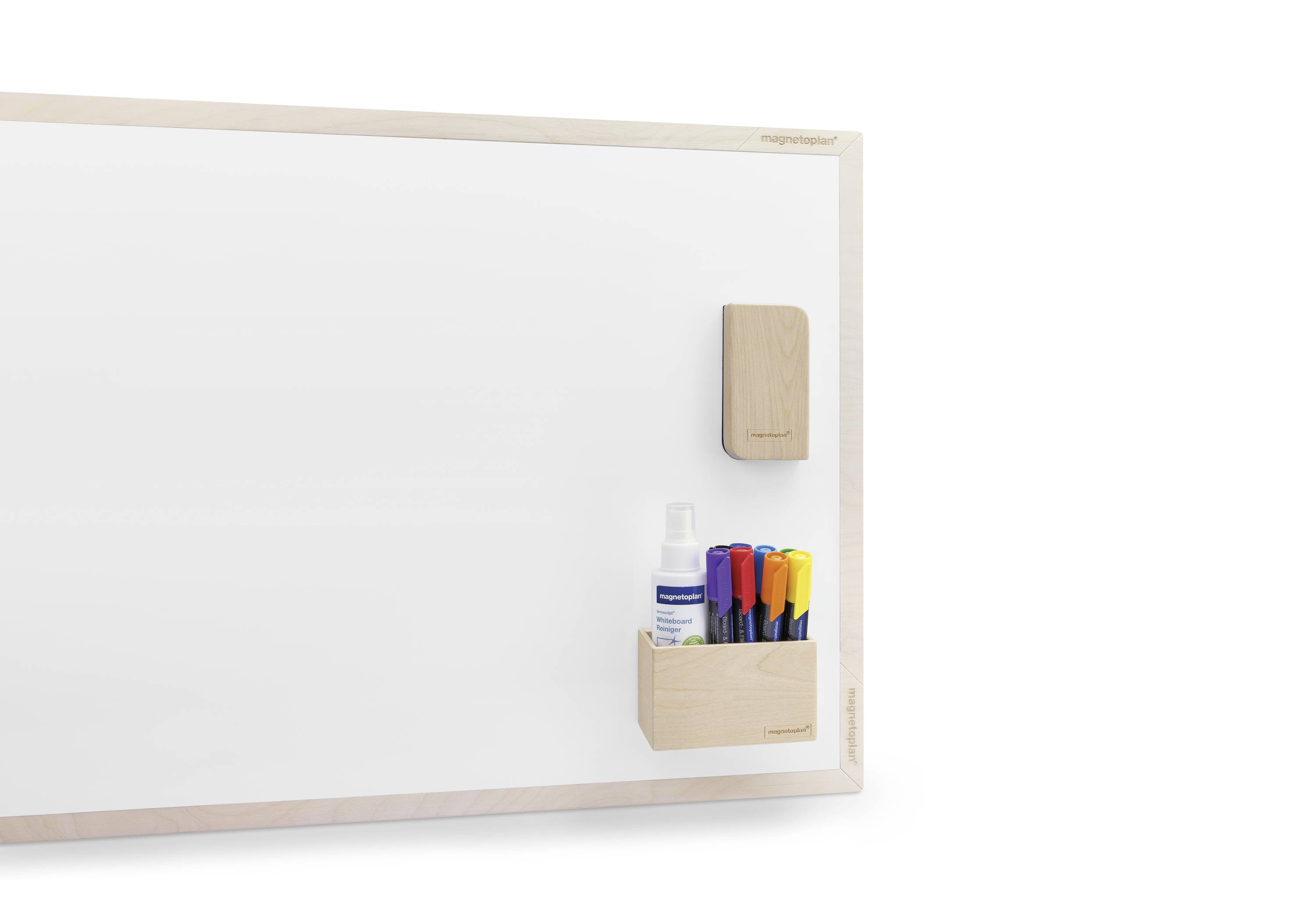 Whiteboard with a wooden frame, with colourful markers and a small container attached in the bottom right corner. A cleaning solution bottle is visible.