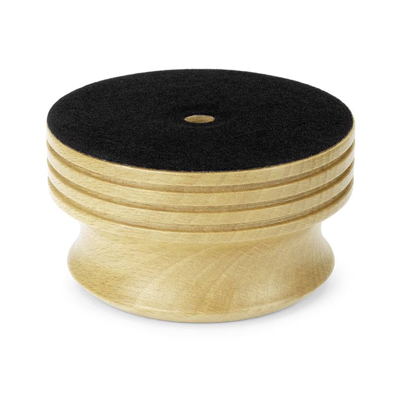 A round, wooden stamp base with a black felt top.