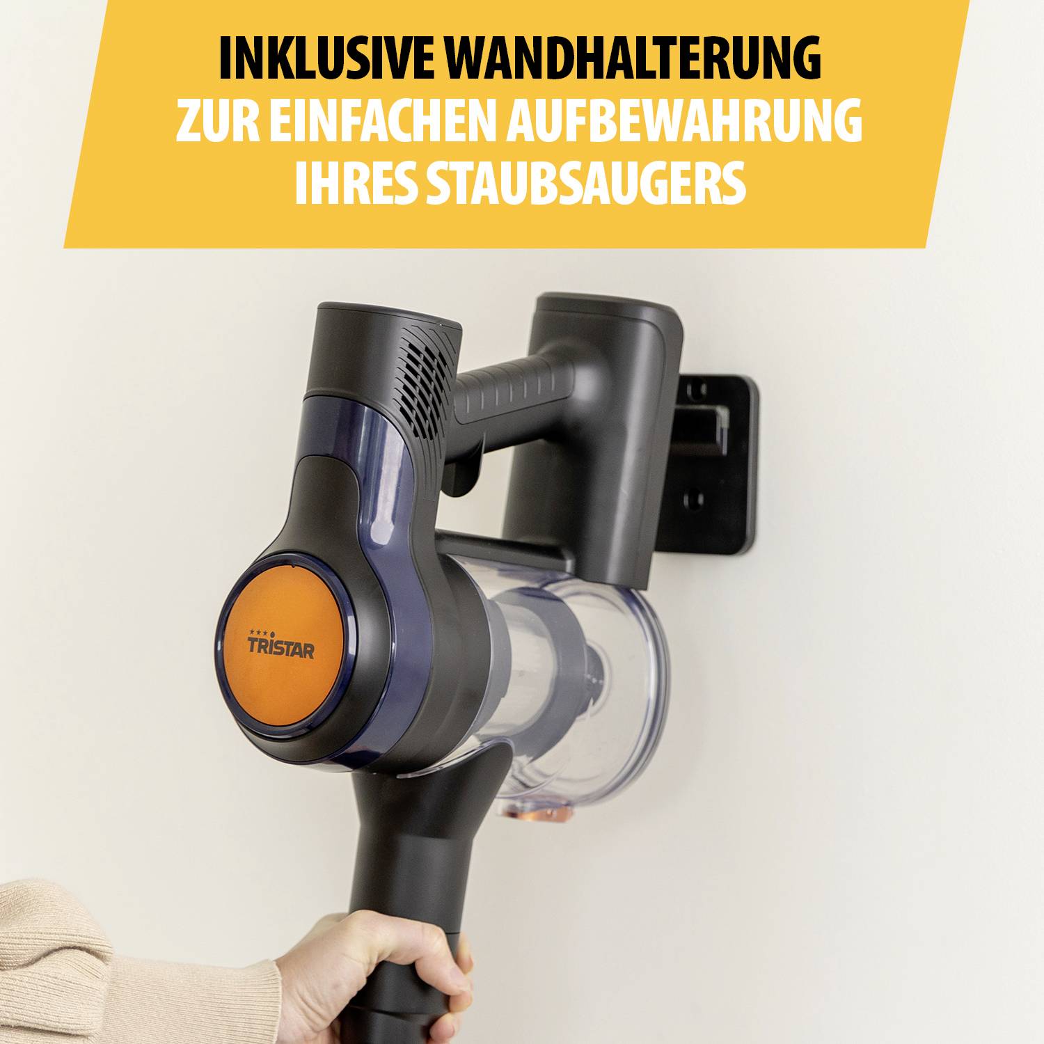 A hand holds a cordless vacuum cleaner mounted in a wall bracket. Above it reads: 'Includes wall mount for easy storage of your vacuum cleaner'.