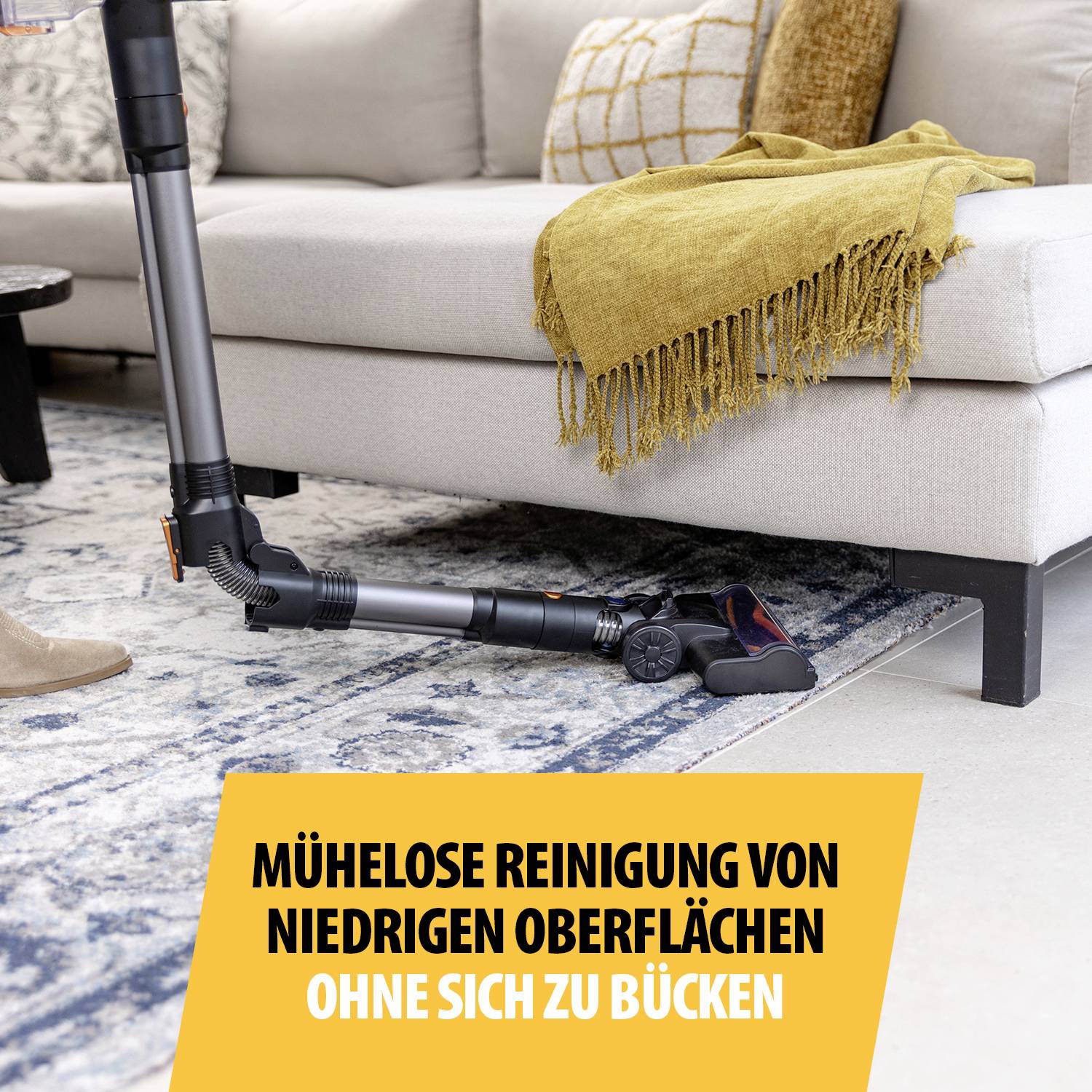 A vacuum cleaner that fits under a sofa, with text: 'Effortless cleaning of low surfaces without bending down'.