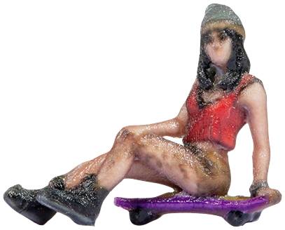 A miniature figure sits relaxed on a purple skateboard. They are wearing a red top, short trousers, a cap, and black boots.