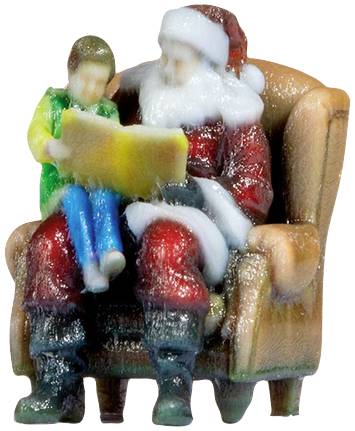 Father Christmas sits with a child on his lap, reading a book together.