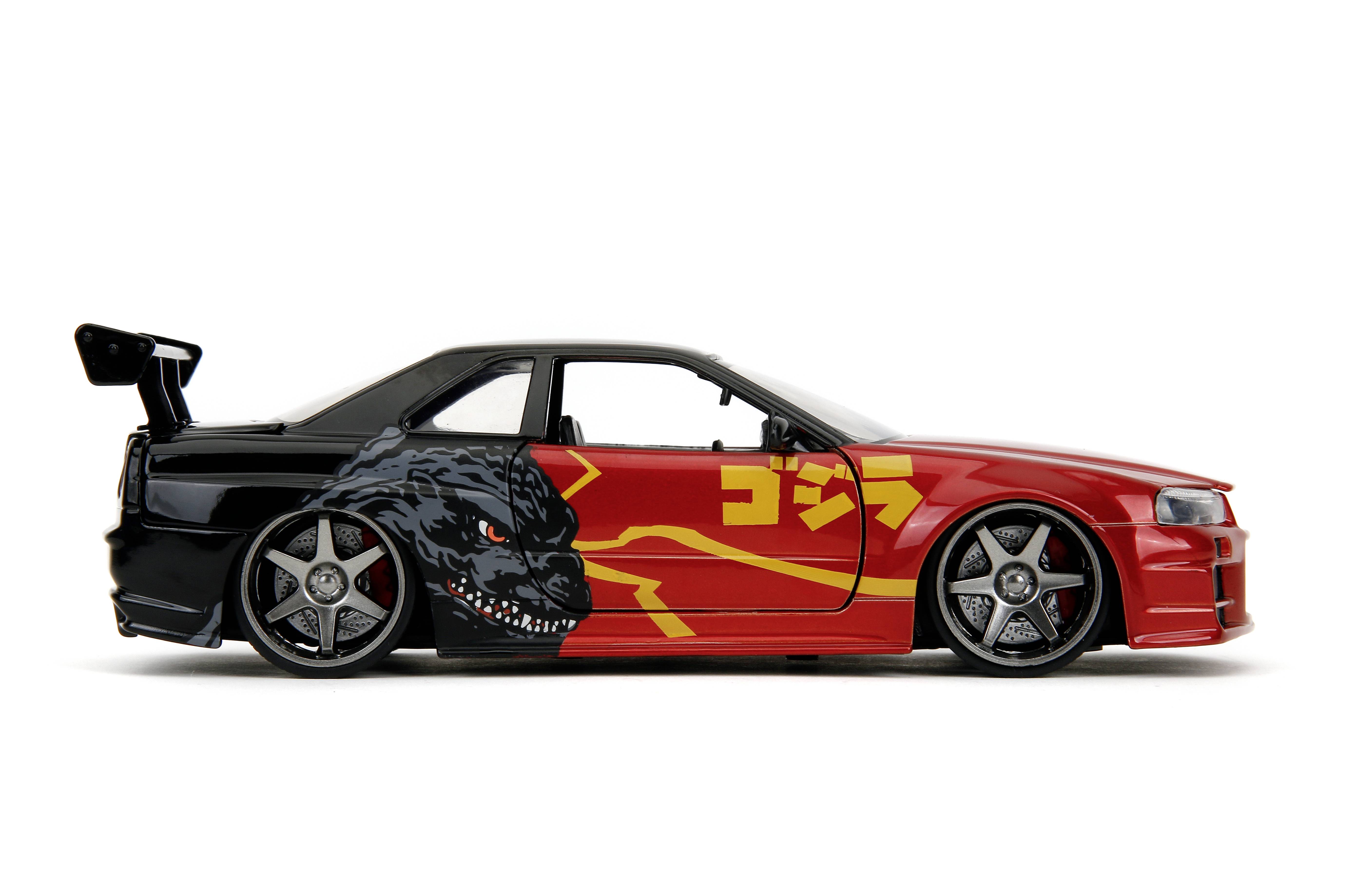 Toy car in a tuning style, painted black and red, with a Godzilla motif on the side.
