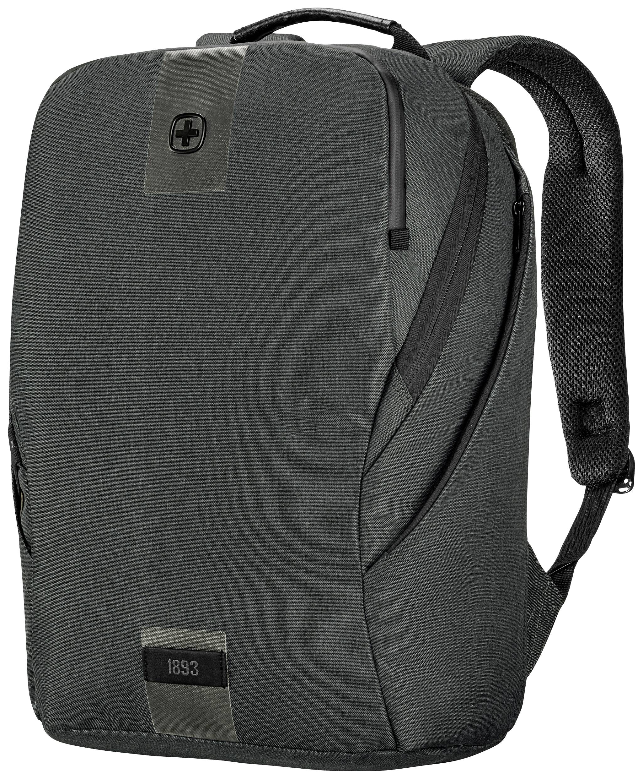 A grey rucksack with a black zip and carry handle on top. The front is decorated with two leather patches, one featuring a cross, the other inscribed with '1893'.