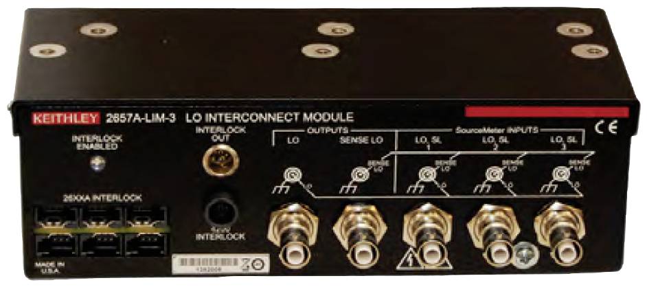 A black electronic device with multiple ports, switches, and a functional diagram on the top surface.