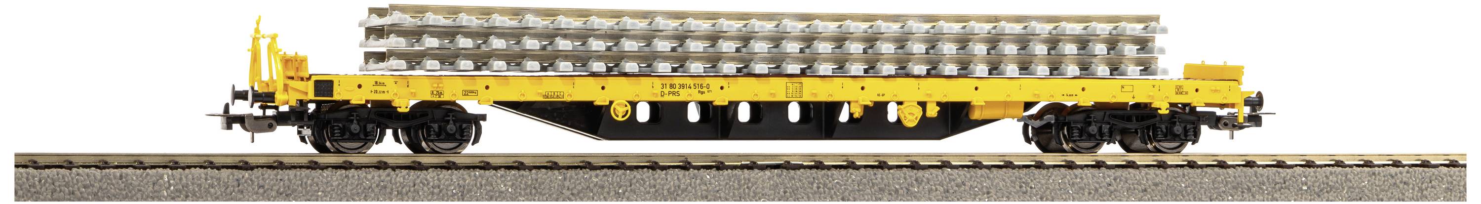 Yellow railway flatbed wagon loaded with concrete sleepers on railway tracks.