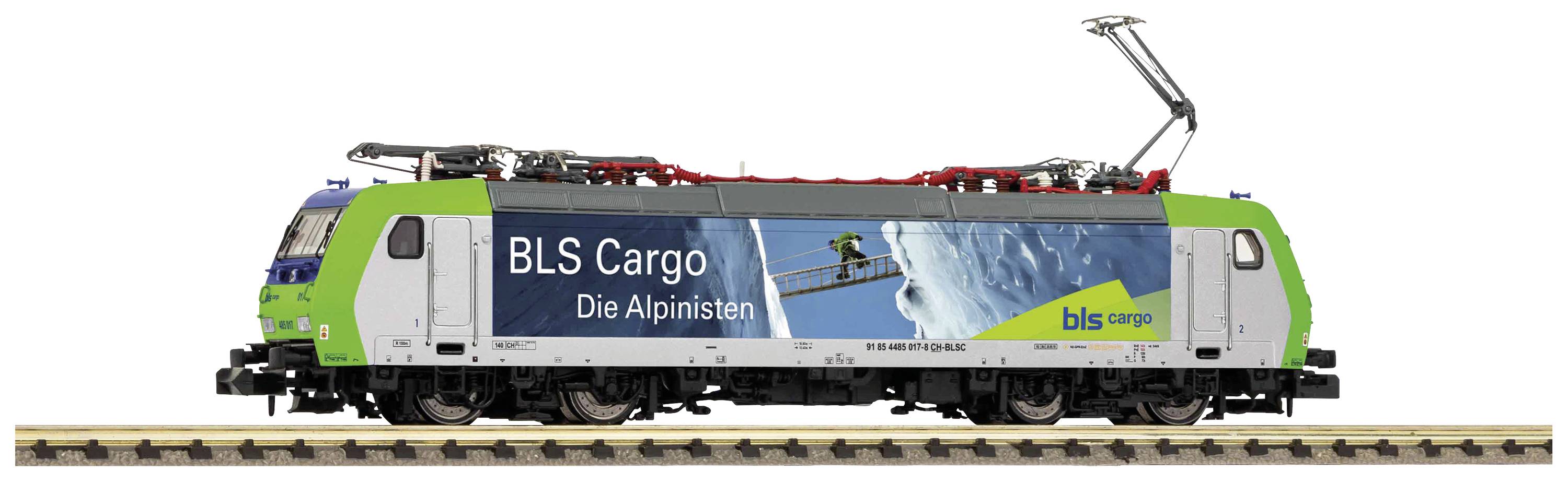 A green locomotive with the inscription 'BLS Cargo The Alpinists' on its side, stands on railway tracks in the studio background.