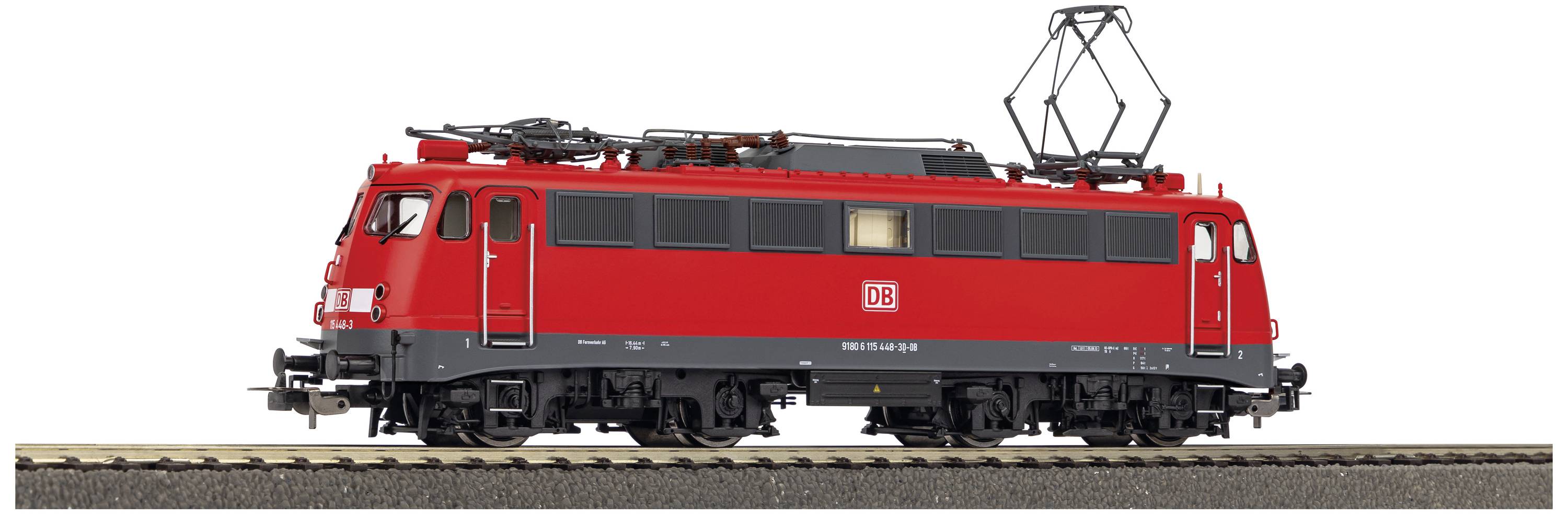 A red model of a German electric locomotive from Deutsche Bahn is standing on a section of railway track.