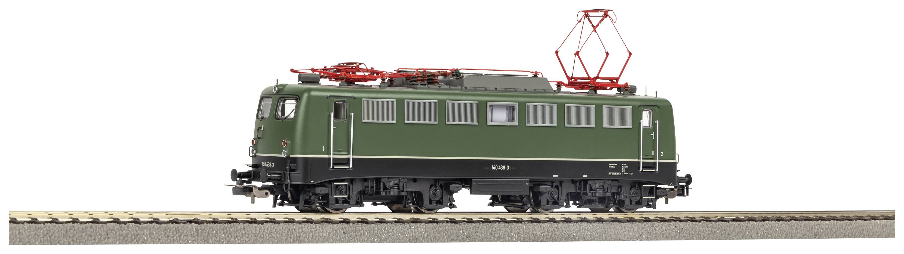Green model electric locomotive on track, side view; detailed replica with red roof current collectors.