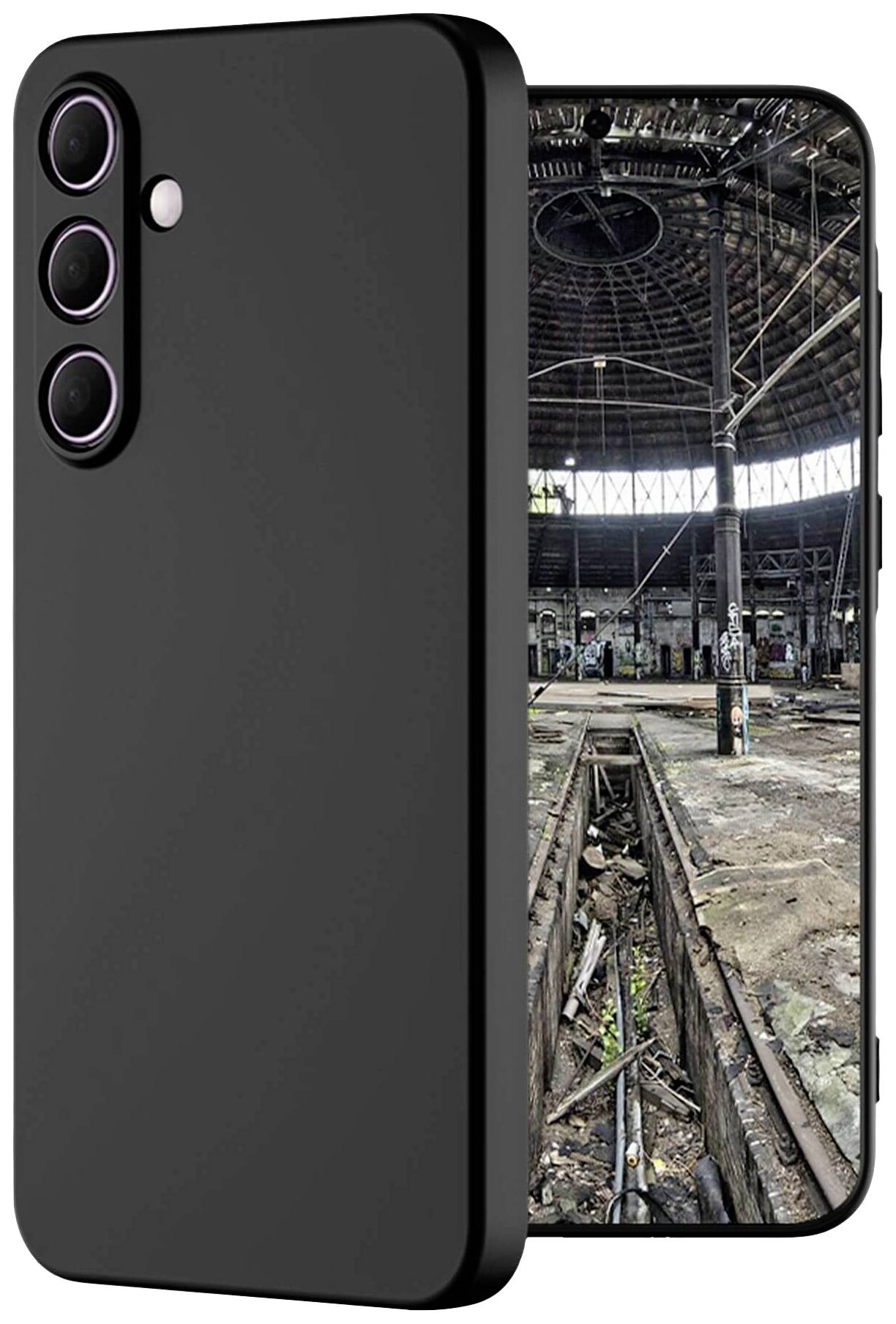 The image depicts a black smartphone with three camera lenses. The screen displays the interior of an abandoned industrial hall.