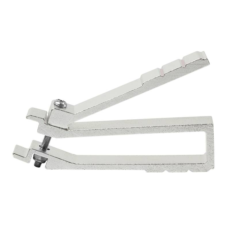 A silver metal tool, likely a clamp or tensioning element, with an adjustment screw on the underside.