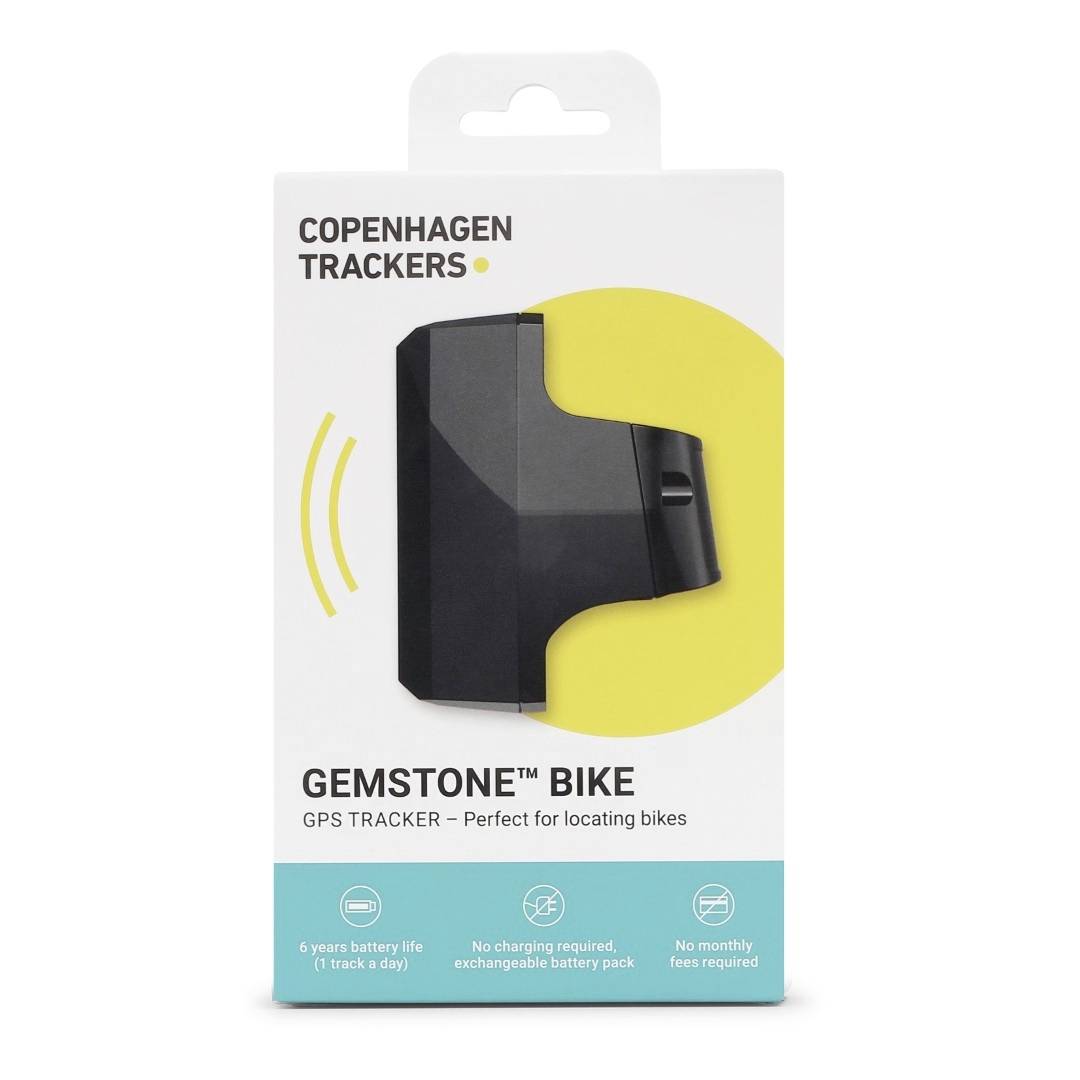 Copenhagen Trackers packaging for the 'Gemstone Bike' GPS Tracker with a yellow circle. Text describes long battery life and no monthly fees.