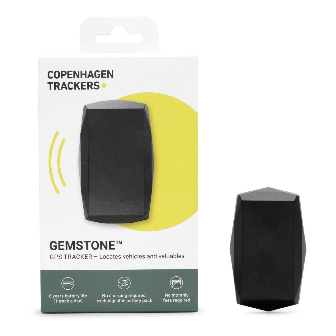 Packaging for a GPS Tracker 'Copenhagen Trackers Gemstone'. Black, faceted tracker beside it. Text: 'Tracking of Vehicles and Valuables'