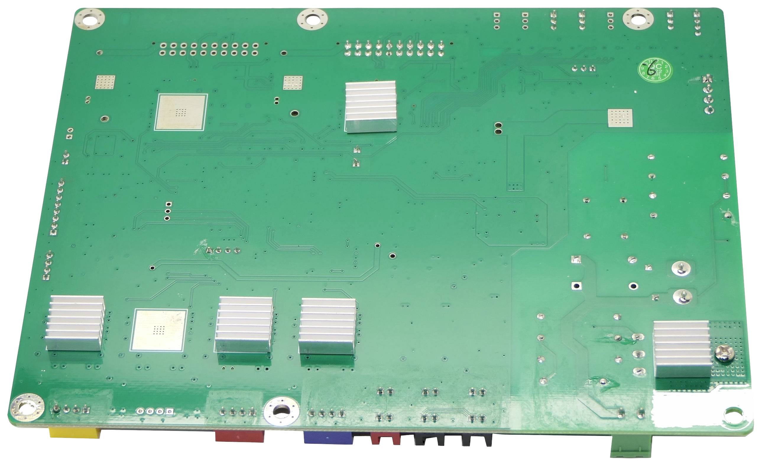Circuit board with various electronic components and connections on a green background.
