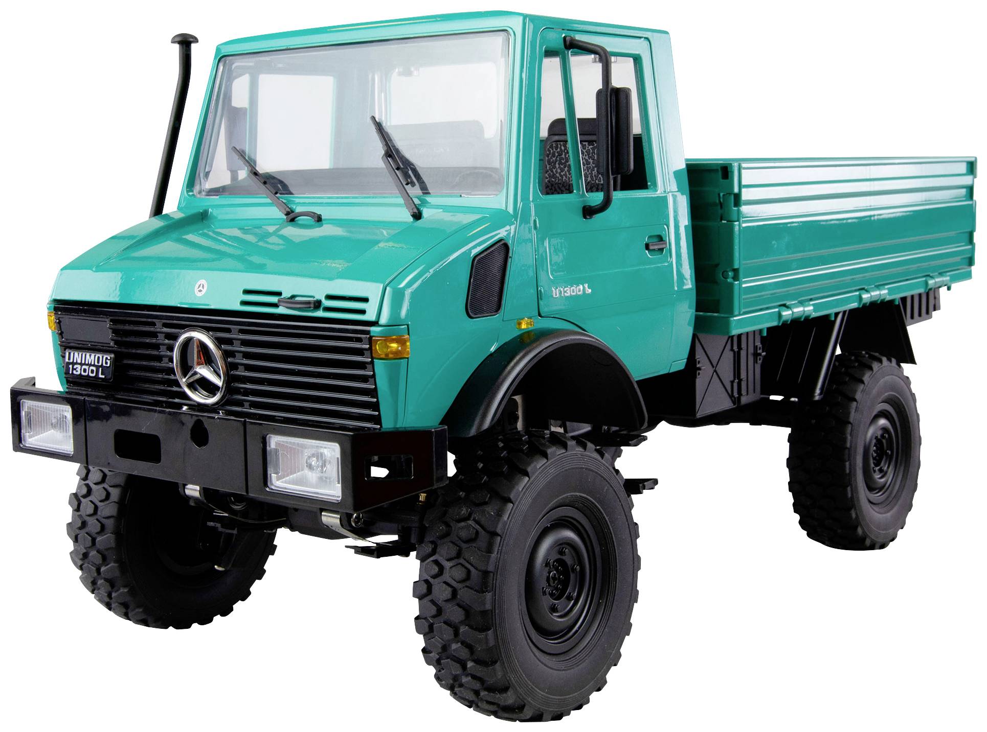Lorry with a green cab and loading area, large tyres; front view. Vehicle is stationary.