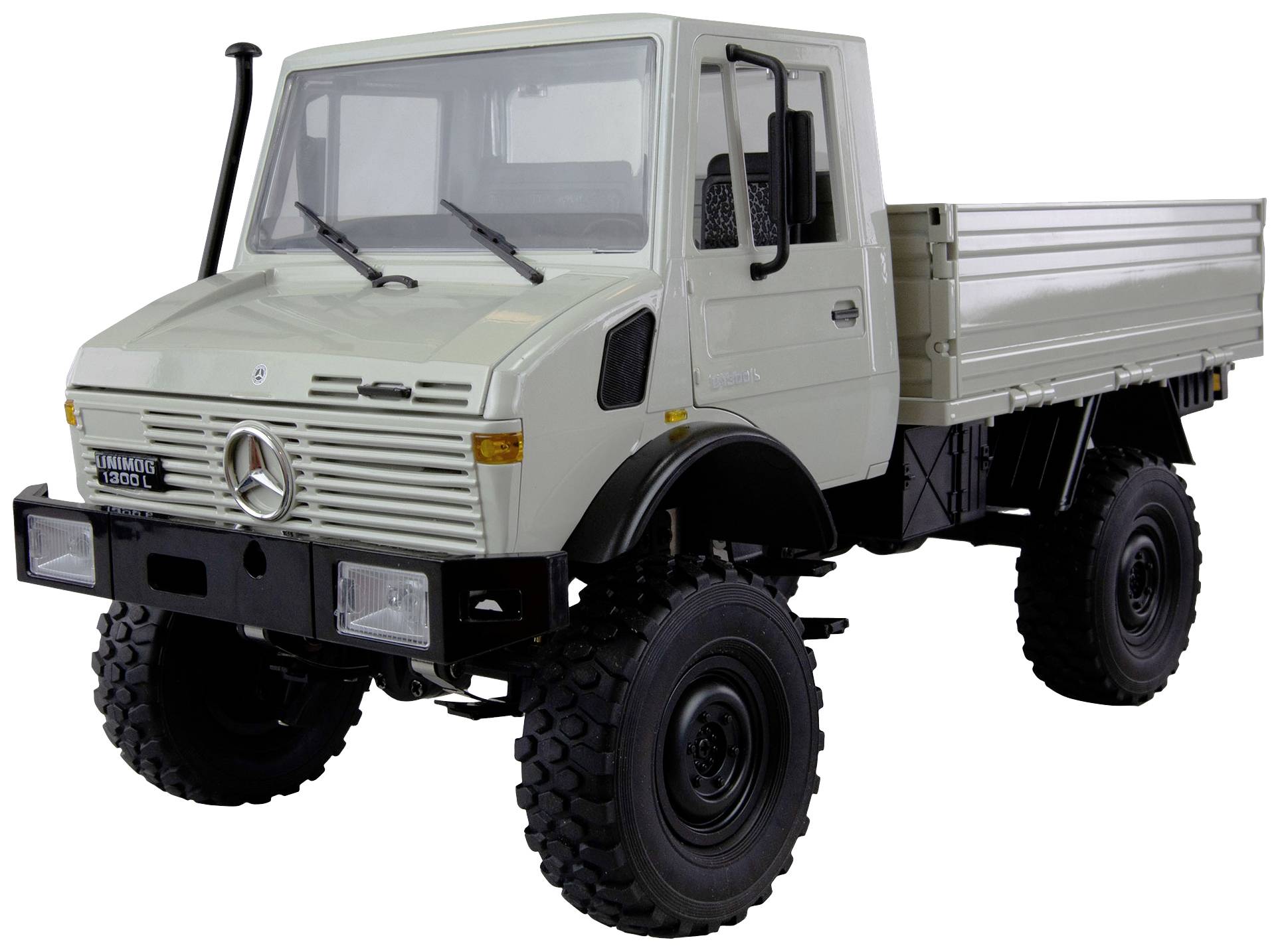 A white off-road vehicle with a load bed, Mercedes logo at the front; robust and functional design for use in challenging terrain.